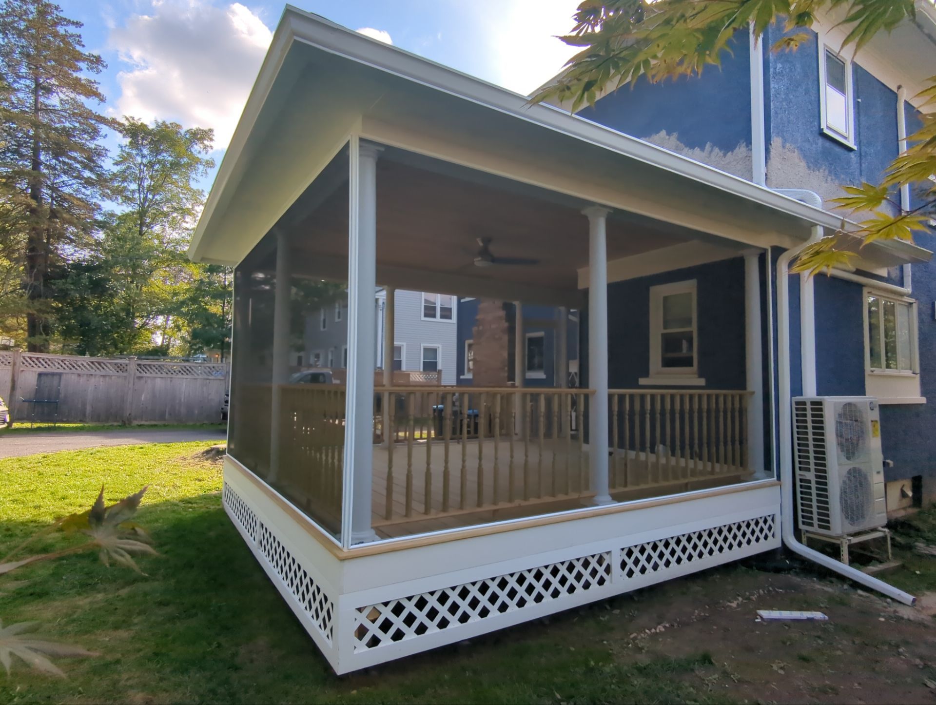 Custom screened porch with architectural columns and hidden screen panels